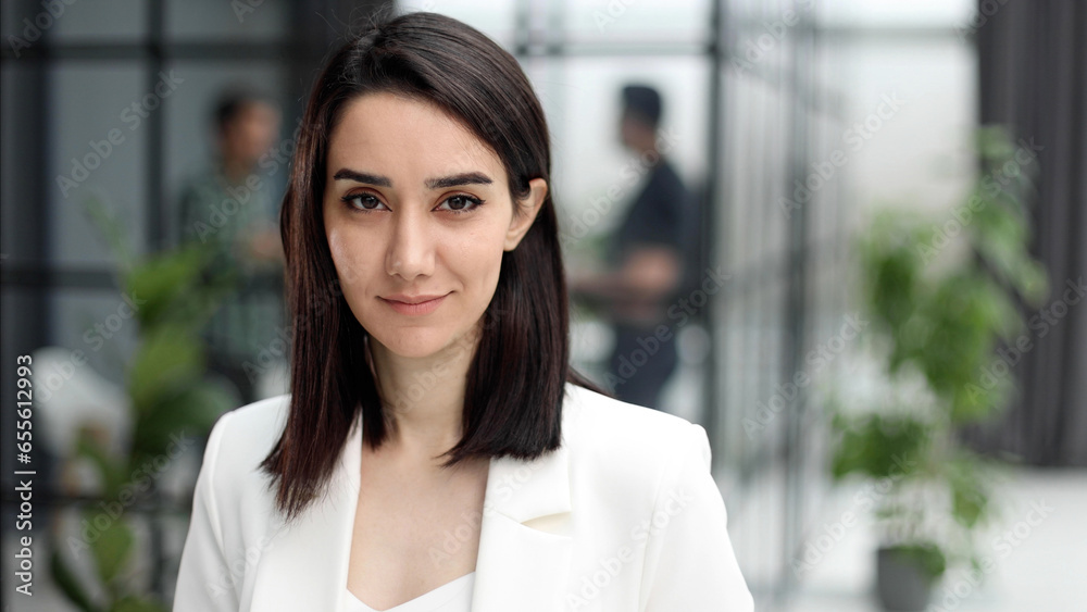 Beautiful young lady in white jacket smiling at camera Beautiful young lady in white jacket smiling at camera