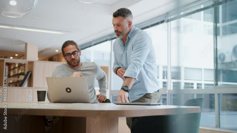 Tech professionals working together to create solutions for their software design project. Business men using a laptop as they discuss ideas for innovative web development.