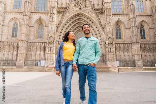 Beautiful happy hispanic latino couple of lovers dating outdoors - Tourists in Barcelona having fun during summer vacation and visiting Barcelona Cathedral historic landmark © oneinchpunch