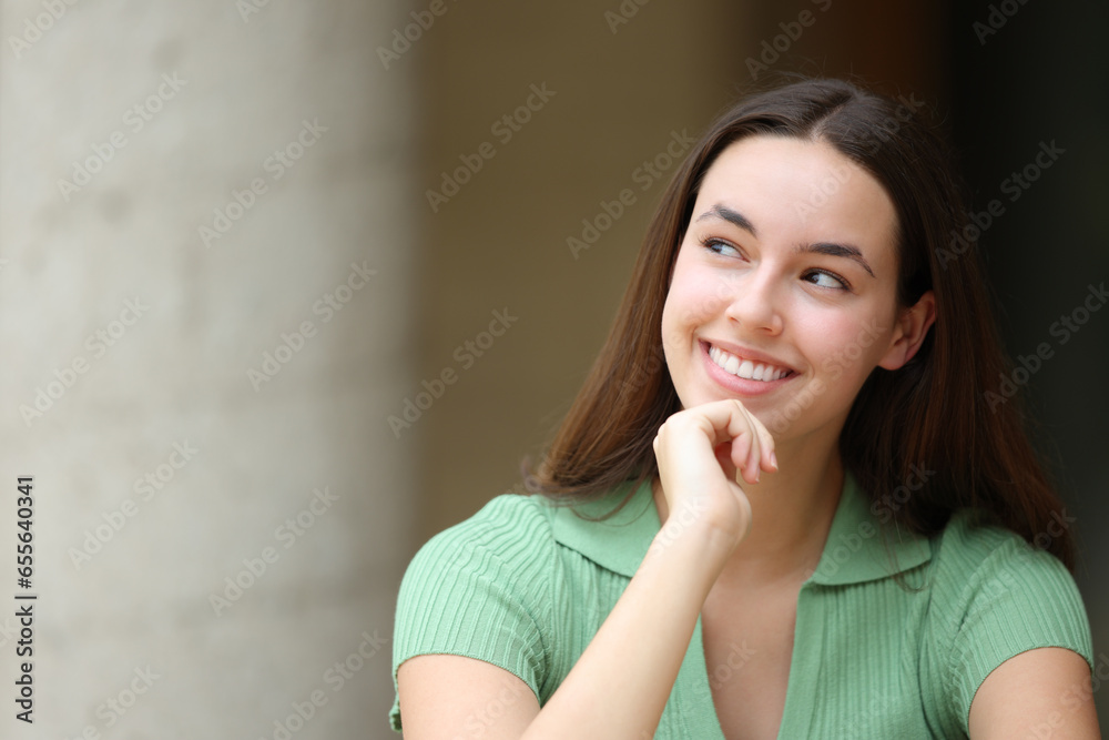 Woman in the street thinking looking at side Woman in the street thinking looking at side