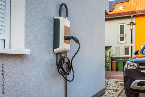 Wallbox on a family house wall for comfortable charging of electric car