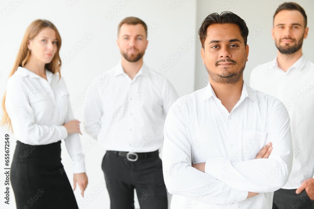 Happy businesspeople laughing while collaborating on a new project in an office. Group of diverse businesspeople working together in a modern workspace Happy businesspeople laughing while collaborating on a new project in an office. Group of diverse businesspeople working together in a modern workspace