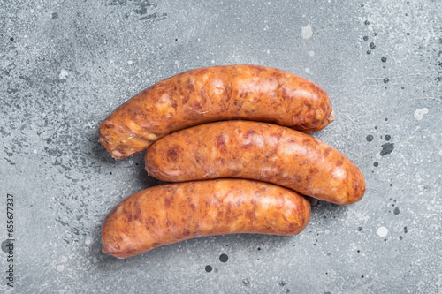 Raw Chorizo sausages for BBQ with spices. Gray background. Top view. Copy space
