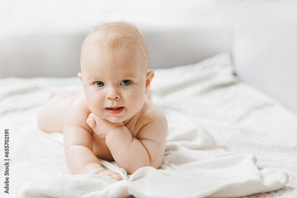 Portrait happy little baby boy after applying body cream. Concept lotion for skin of infant Portrait happy little baby boy after applying body cream. Concept lotion for skin of infant