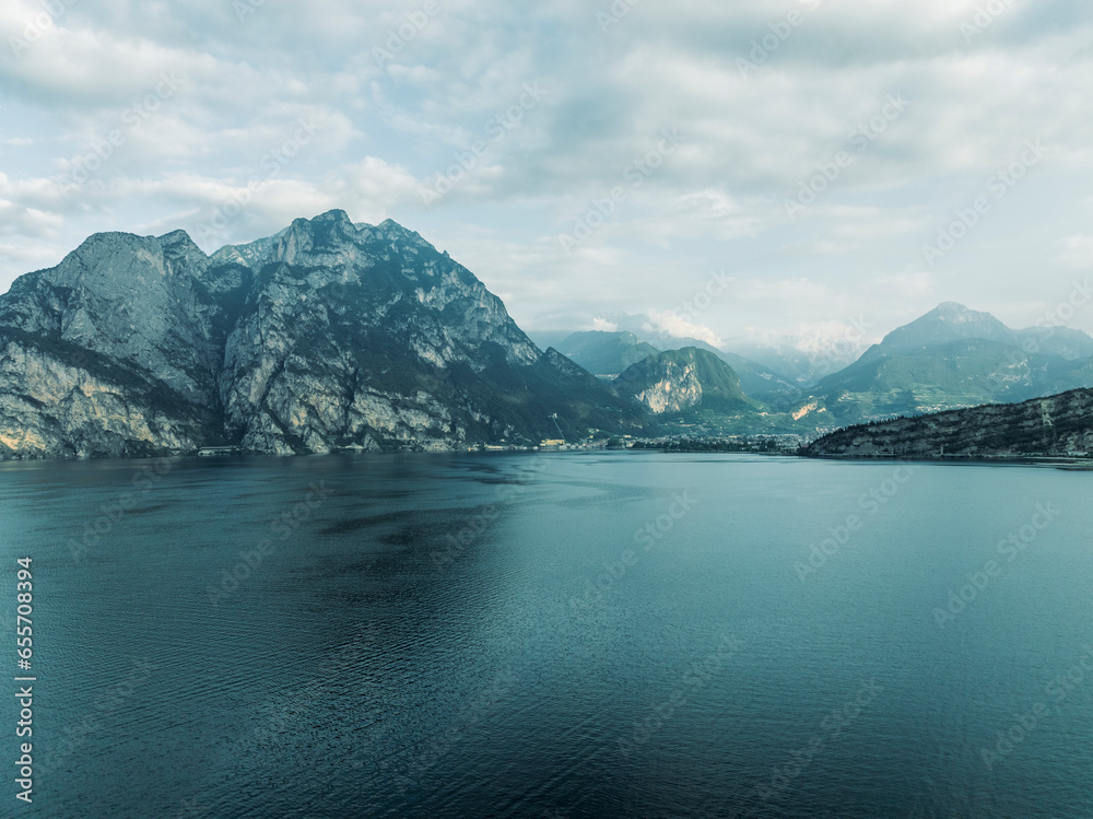 Aerial view of the Garda Lake at sunrise with high mountains near Torbole, Trentino, Italy. Aerial view of the Garda Lake at sunrise with high mountains near Torbole, Trentino, Italy.
