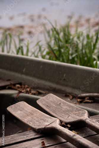 Old oars in a rowing boat by the lake
