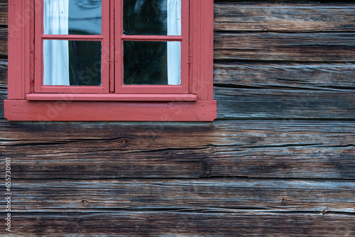 Old darkened log wall under the window