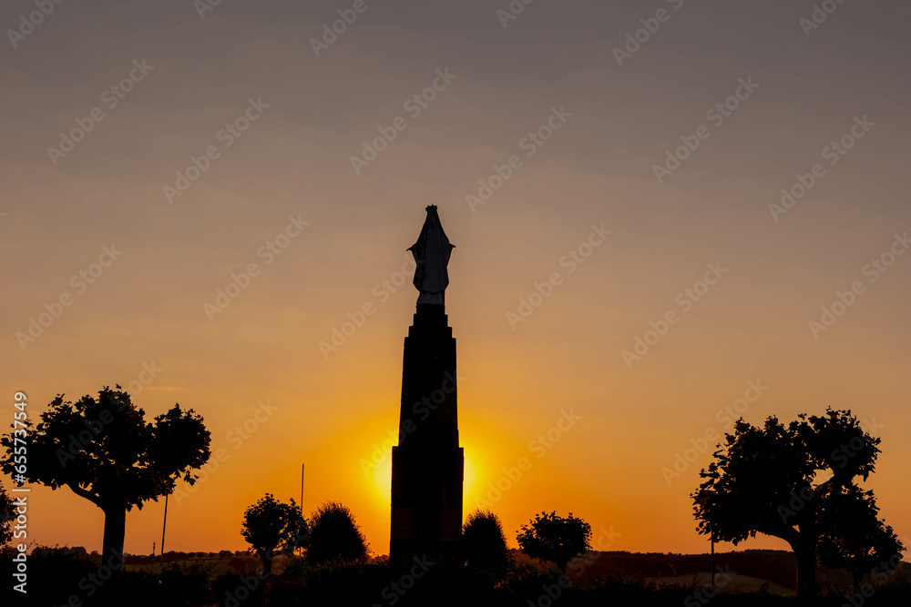 Silhouette statue of Maria Monument at Gulperberg in the evening during sunset, The terrain hilly countryside in Zuid-Limburg in summer, Gulpen is a villages in Dutch province of Limburg, Netherlands.