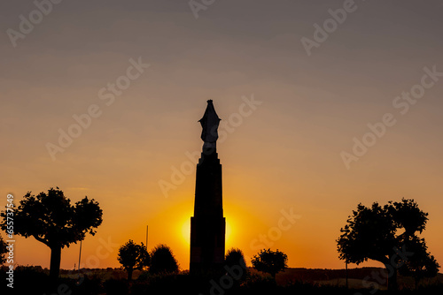 Silhouette statue of Maria Monument at Gulperberg in the evening during sunset, The terrain hilly countryside in Zuid-Limburg in summer, Gulpen is a villages in Dutch province of Limburg, Netherlands. photo