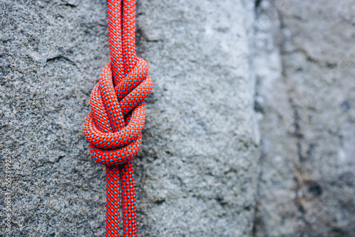 eight climbing knot with colorful rope on rocky background photo