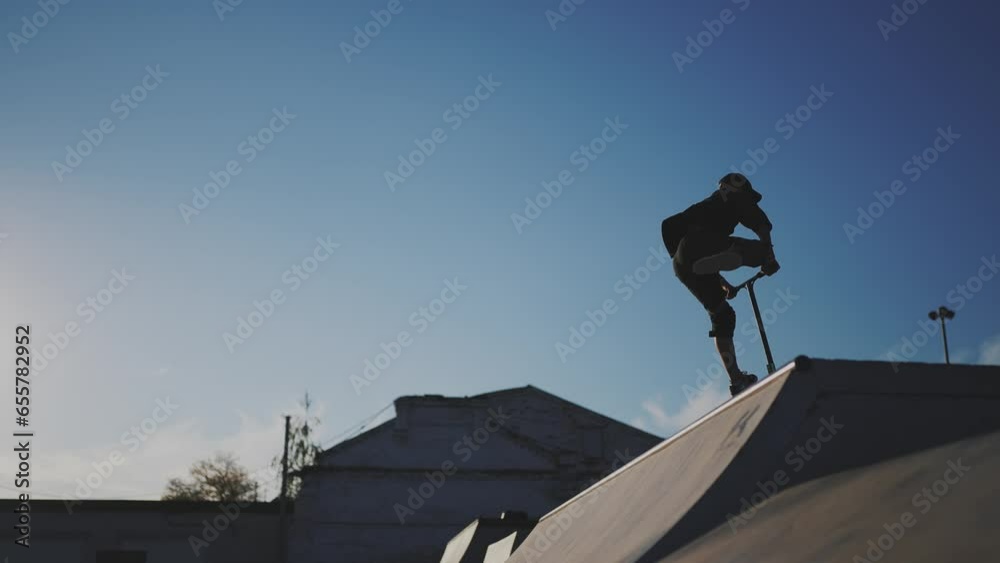 guy riding a skateboard. city landscape glare of the sun. height extreme. brave guy jumping high on a skateboard. daytime city. form content lifestyle guy riding a skateboard. city landscape glare of the sun. height extreme. brave guy jumping high on a skateboard. daytime city. form content lifestyle