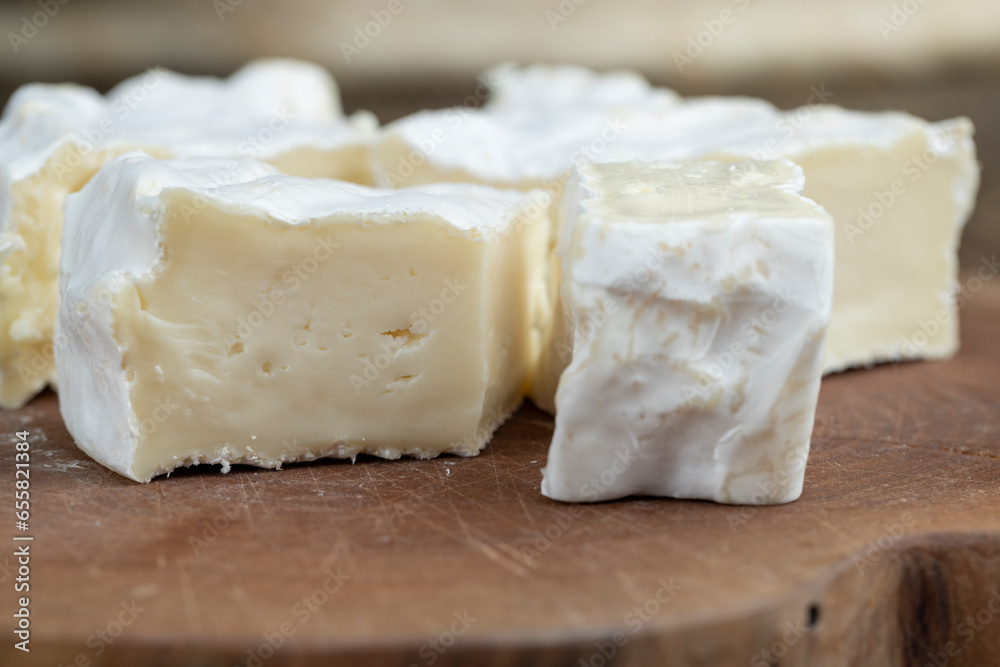 delicious white cheese sliced on a board