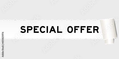 Ripped gray paper background that have word special offer under torn part