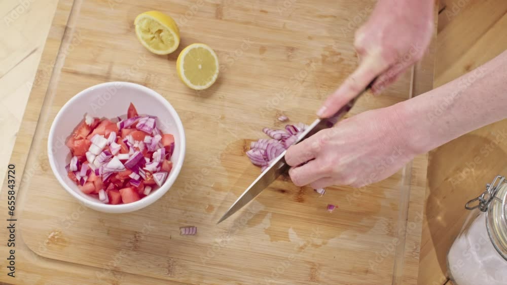 Home chef making salsa in the kitchen - chopping red onion. Closeup shot. Home chef making salsa in the kitchen - chopping red onion. Closeup shot.