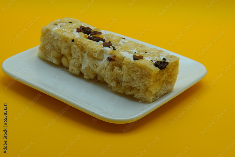 Chinese traditional dessert - Caramel treats, Sachima. yellow background
