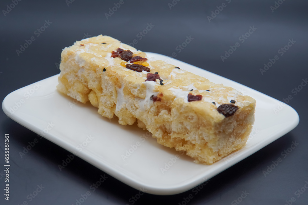 Chinese traditional dessert - Caramel treats, Sachima. dark background Chinese traditional dessert - Caramel treats, Sachima. dark background