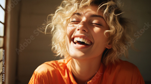 portrait of a bleach blond model laughing, warm yellow accents