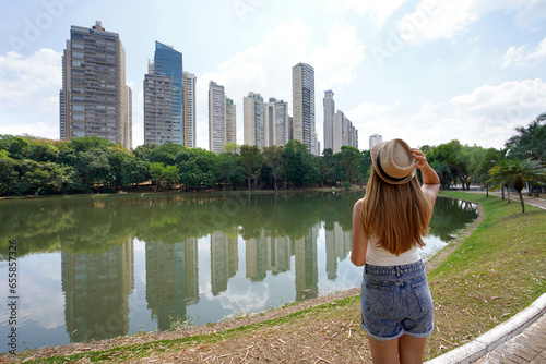 Tourism in Goiania, Brazil. Back view of beautiful girl with hat in the Parque Areiao, a city park in Goiania, Goias, Brazil. photo