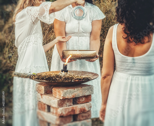 Women at the ceremony with water, ceremony space.