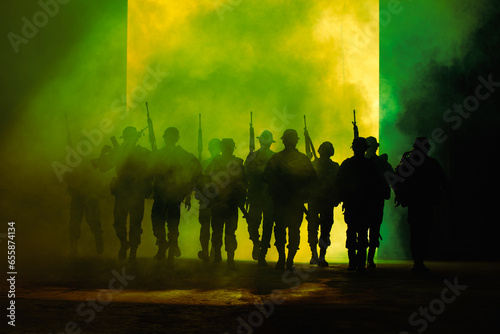 silhouette group of soldiers special forces full team in uniform walking action through smoke fire and holding gun on hand over lighting background,
