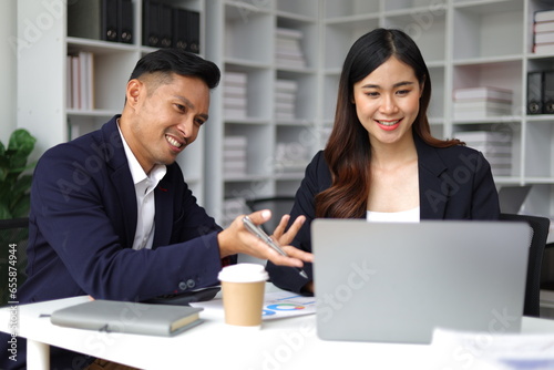 Boss and secretary working on documents together in office. Businessman and colleagues discussing in office collaboration.