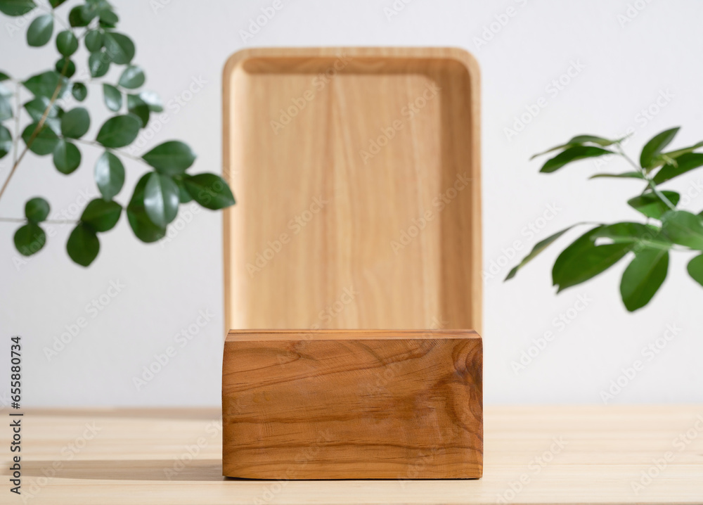 Minimal wood podium table top blurred green leaf plant on white empty space nature background.Beauty cosmetic natural product modern wooden display. Minimal wood podium table top blurred green leaf plant on white empty space nature background.Beauty cosmetic natural product modern wooden display.