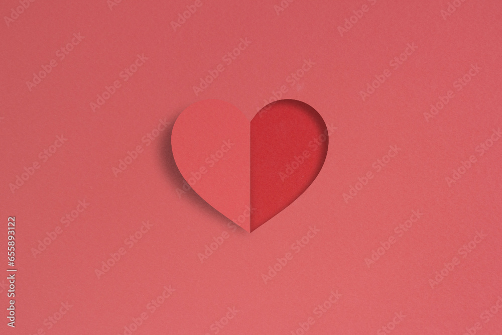 red heart shaped paper cut on pink background red heart shaped paper cut on pink background