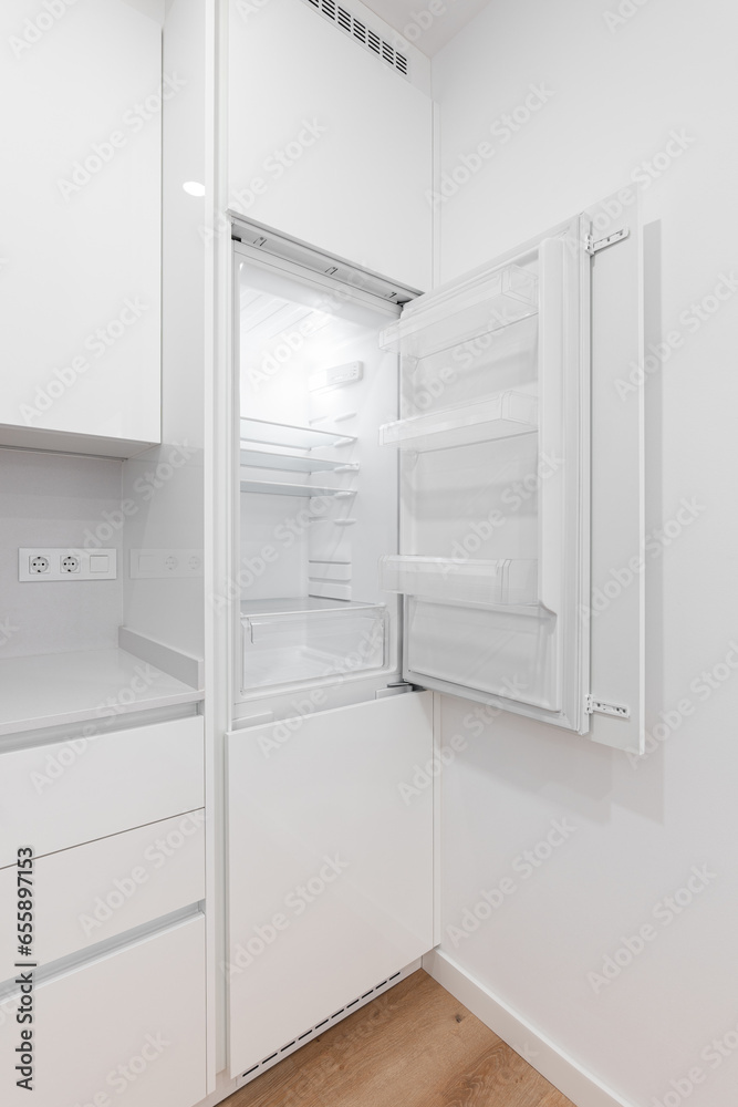 Photo of a modern white refrigerator freezer in a contemporary kitchen Photo of a modern white refrigerator freezer in a contemporary kitchen