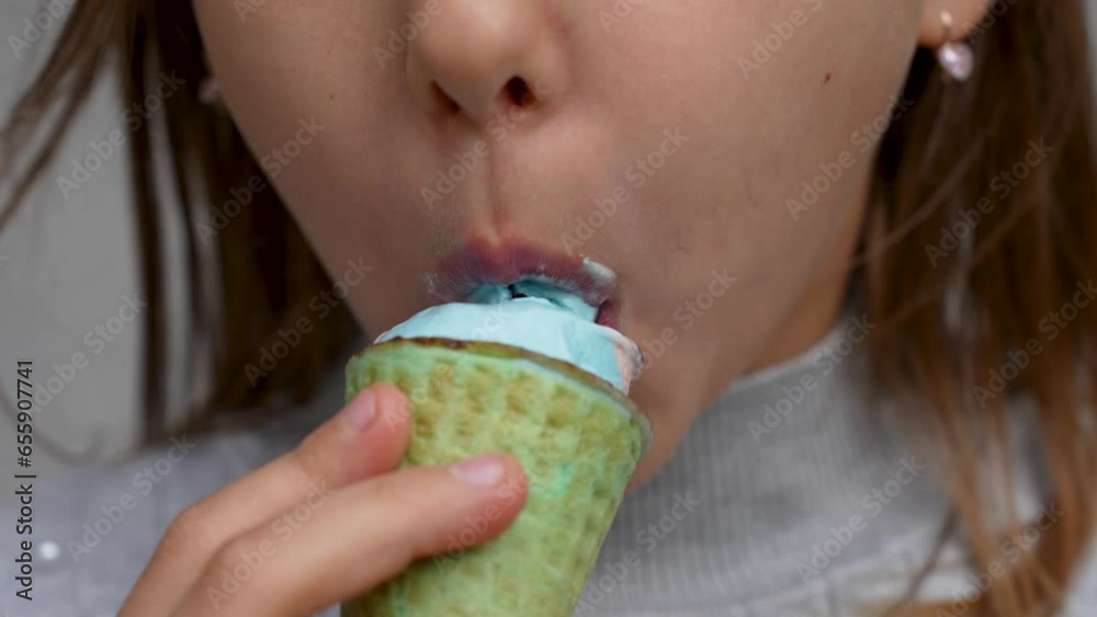 Child with ice cream on grey background, close-up