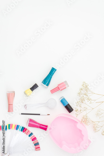 Bright gel varnishes with manicure and pedicure beauty tools, top view