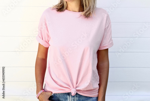 Girl in template blank pink t shirt isolated on white blur wooden background. pink tshirt for your design
