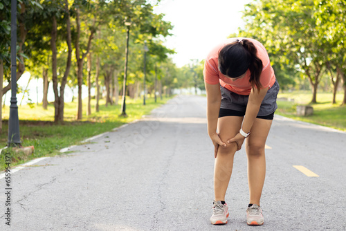 Injury and recovery in sports, Female holding her sore leg after accident. Runner woman massaging sore calf muscles during running training outdoor from pain. Athlete with joint or muscle soreness. photo
