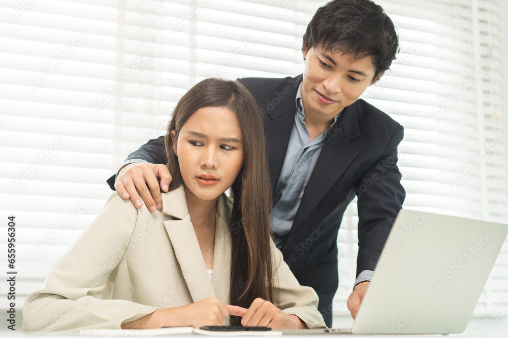 Disgusted asian young employee, pressure business woman uncomfortable, looking hand of boss or colleague when touching her shoulder, embrace. Sexual harassment inappropriate at office, workplace. Disgusted asian young employee, pressure business woman uncomfortable, looking hand of boss or colleague when touching her shoulder, embrace. Sexual harassment inappropriate at office, workplace.