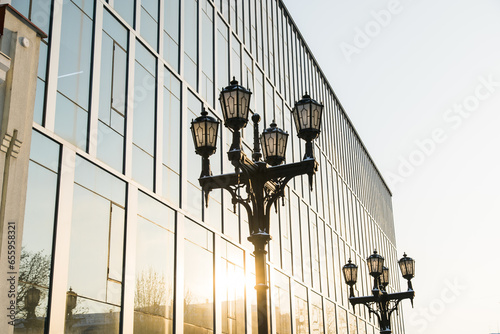 Street light in city winter season on background a glass facade building. Copy space and empty place for text and advertising
