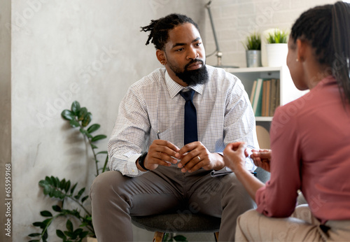 A psychotherapist session with a patient. African-American women and men have a meeting. 