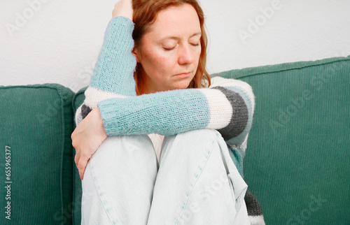 Obraz na płótnie Depression. Woman sitting alone on sofa in depressed mood w salonie