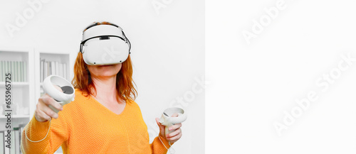 Obraz na płótnie woman playing VR glasses. Sport in virtual reality. The concept of metaverse, virtual reality, future, technology and internet of things. w salonie