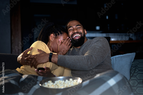Fotografie African American couple watching a movie at home over a streaming cable service