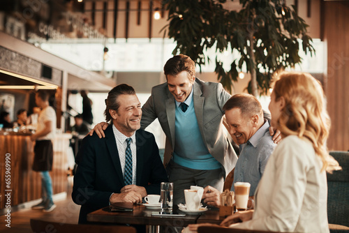 Group of business coworkers or colleagues having a business meeting in a cafe