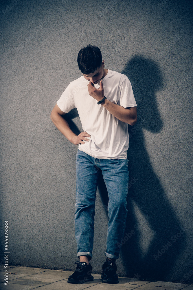 guy near a gray wall guy near a gray wall