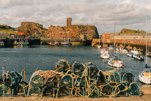 Constructed of wood and netting, these lobster pots, or traps, are stacked for storage while the lobster fishing season is closed.