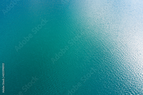 Clear water surface of an abandoned granite quarry. The background. Drone. Aerial view