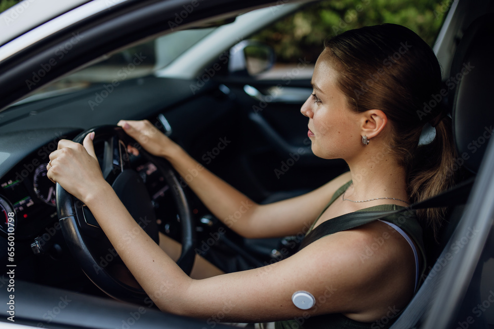 Woman with diabetes monitoring her blood sugar during car drive. Woman with diabetes monitoring her blood sugar during car drive.
