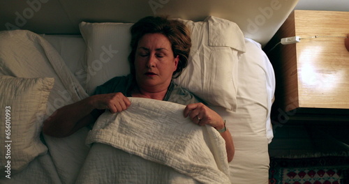 Fotografia Worried older woman lying in bed unable to sleep