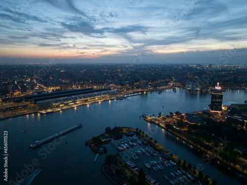 Canvas Print Aerial drone view of Amsterdam city skyline at night, Ij river, ferries, transportation over water