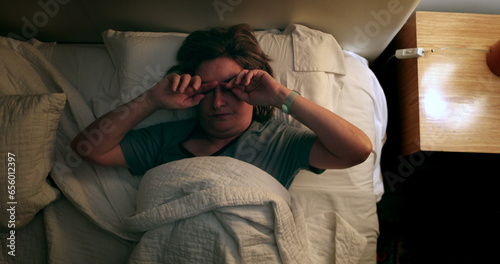 Tablou pe pânză Worried older woman lying in bed trying to sleep
