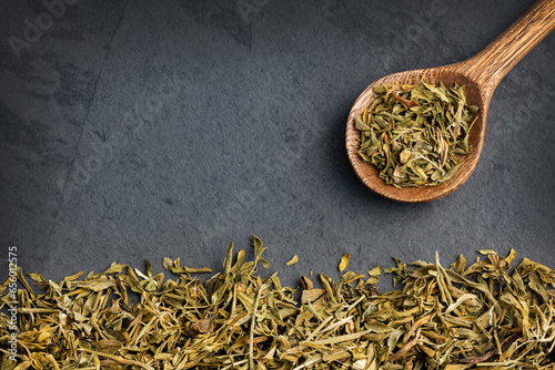 Ruta graveolens - Dried rue leaves in the spoon photo