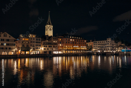 View of historic Zurich city center with famous Fraumunster Church and river Limmat at Lake Zurich , in twilight, Canton of Zurich, Switzerland.