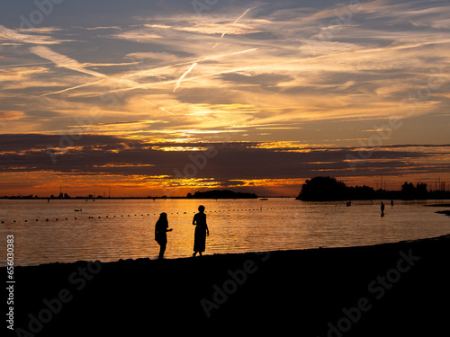 silhouette of two girls at the beach.