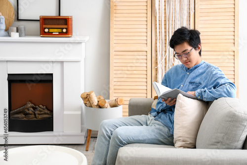 Young man reading book on s...
